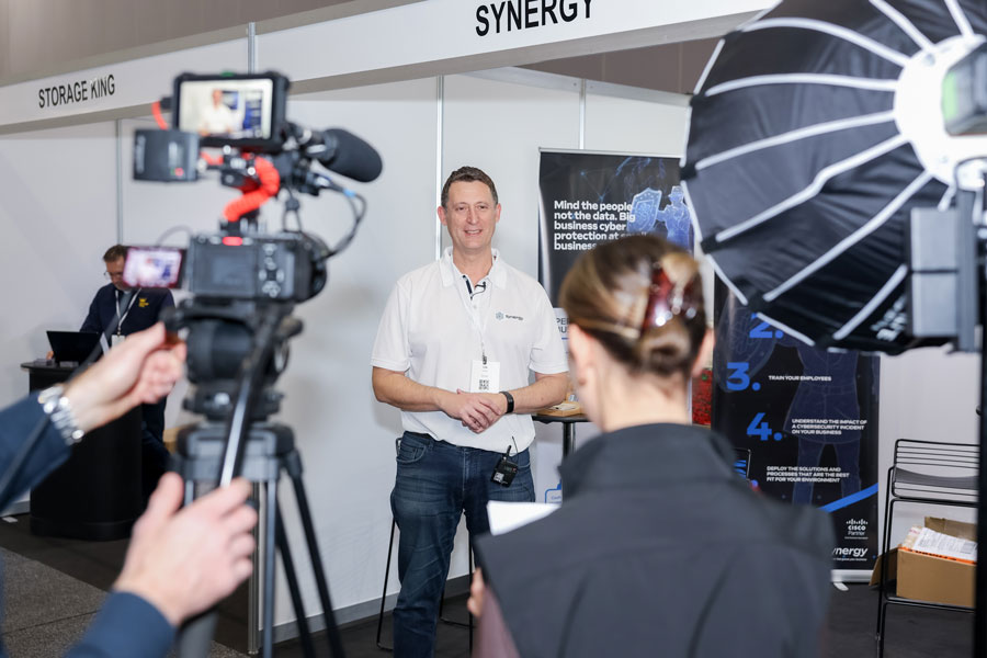 SmallBiz Melbourne exhibitor being filmed for a media interview on the expo floor