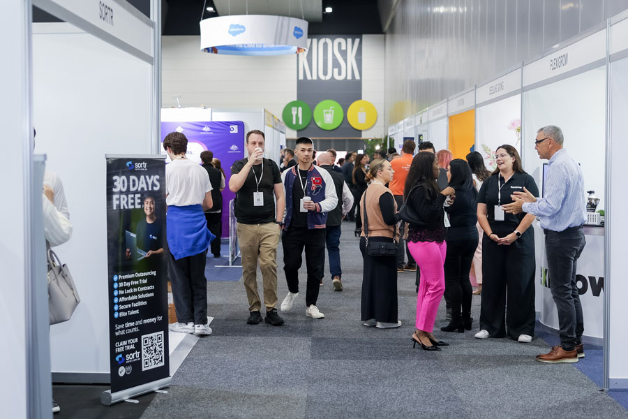 SmallBiz Expo floor with exhibitor booths and business attendees